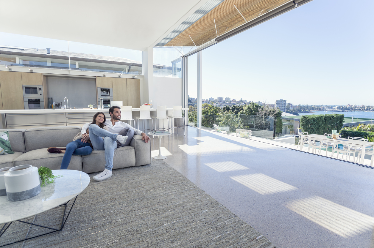 Couple sitting in a modern open plan house.